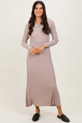 woman wearing a ribbed beige long sleeve maxi dress and black slip-on shoes