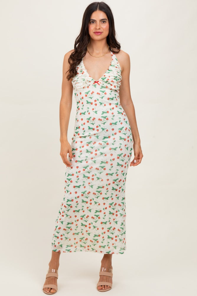 woman wearing a white floral print spaghetti strap maxi dress with a ruched bodice and a fitted silhouette