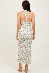 woman wearing a white floral tie-back midi dress with a fitted silhouette and a flowy hem
