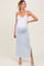 woman wearing a light blue floral maternity maxi dress with adjustable straps and a side slit, showing her baby bump