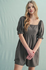 woman wearing a brown checkered short dress with puff sleeves and a square neckline