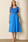 woman wearing a blue short sleeve dress with a fitted top and flowy skirt