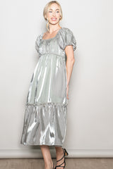 woman wearing a silver puff sleeve midi dress with a tiered skirt and a square neckline