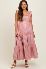 woman wearing a pink and white gingham maternity maxi dress with ruffles and buttons