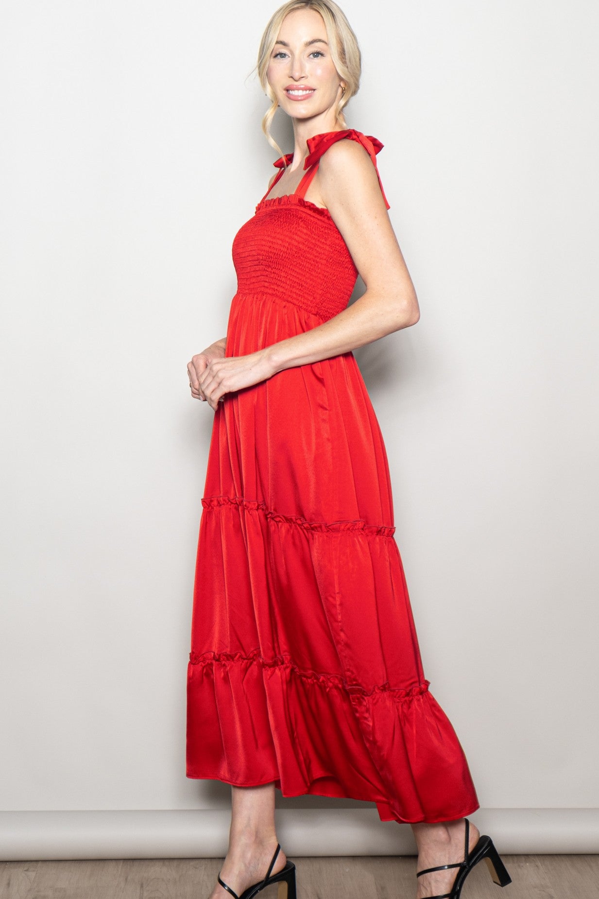 woman wearing a red tiered maxi dress with smocked bodice and tied straps
