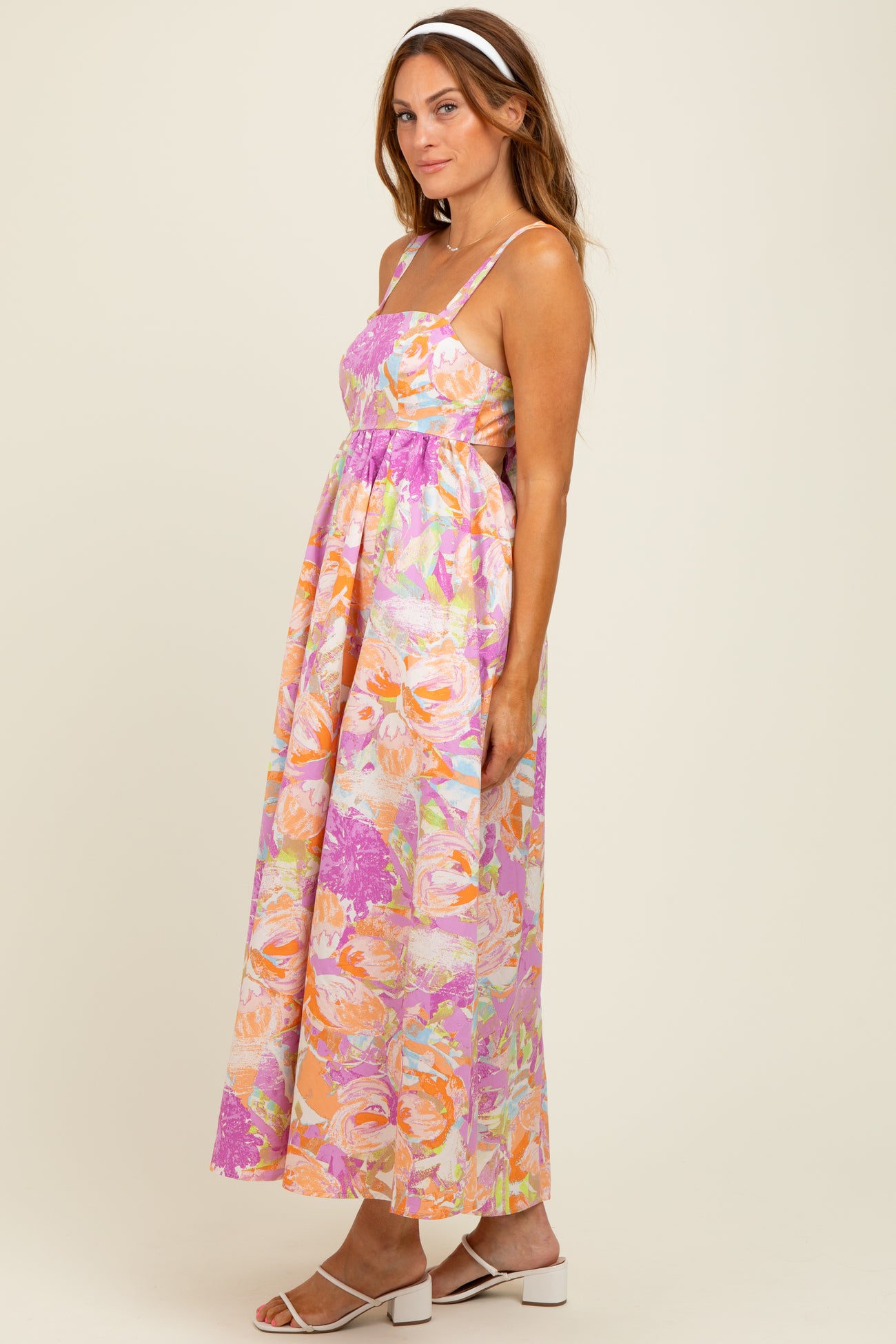 woman wearing a floral maxi dress with spaghetti straps in pastel colors