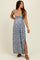 woman wearing a blue floral maternity maxi dress with a cutout detail and side slits, showcasing her baby bump