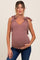 woman wearing a mauve maternity tank top with tie straps and holding her baby bump