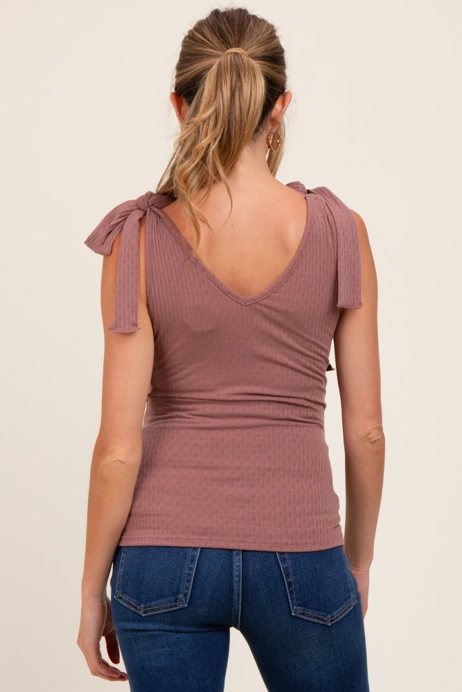 woman wearing a mauve maternity top with tie-shoulder details and a fitted style, showing her back