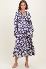 woman wearing a floral long sleeve purple maxi dress with a v-neck and gathered waist detail