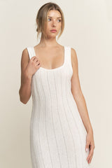 woman wearing a white ribbed knit sleeveless dress with a scoop neckline and fitted silhouette