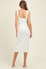 woman wearing a white ribbed midi maternity dress with a scoop back and fitted silhouette