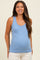woman wearing a light blue ribbed maternity tank top and showing her baby bump