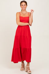 woman wearing a red tiered maxi dress with spaghetti straps and a scalloped neckline