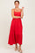 woman wearing a red tiered maxi dress with spaghetti straps and a scalloped neckline