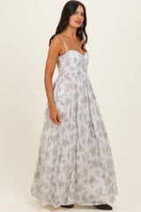 woman wearing a sleeveless floral maxi dress with a sweetheart neckline and flowy skirt