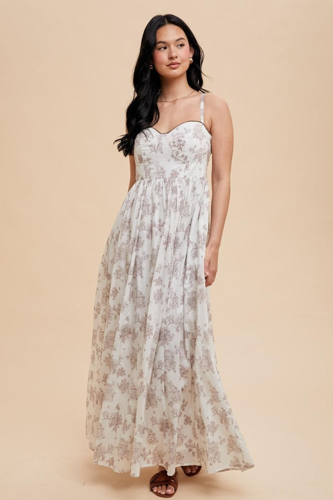 woman wearing a floral print maxi dress with spaghetti straps and a sweetheart neckline