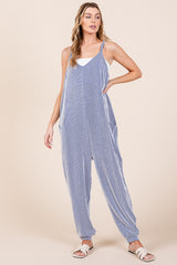woman wearing a blue and white striped jumpsuit with wide legs and side pockets