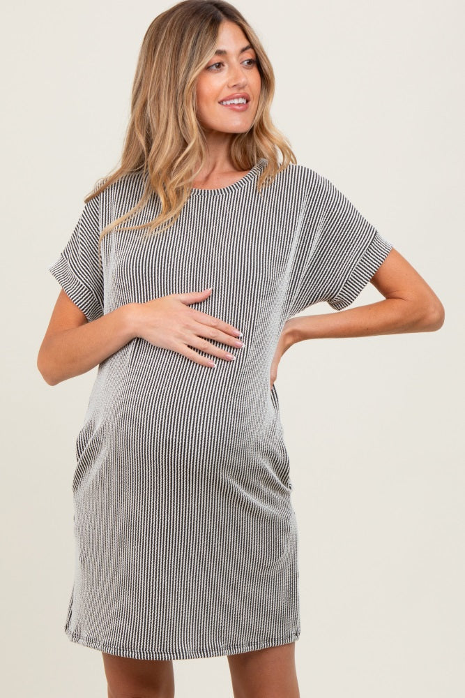 woman wearing a striped maternity t-shirt dress and holding her baby bump