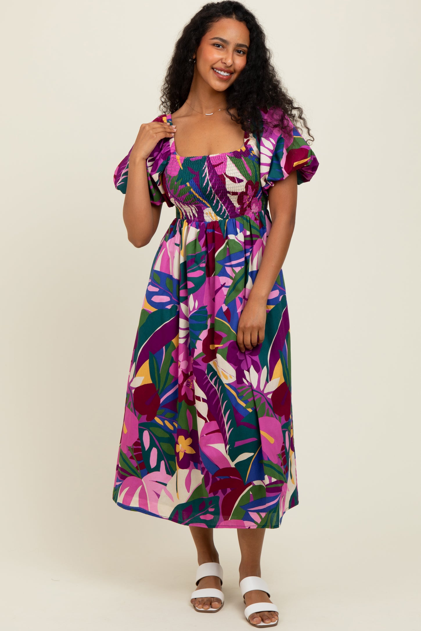 woman wearing a multicolored floral maxi dress with ruffled sleeves and a smocked bodice
