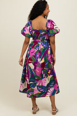 woman wearing a colorful floral print midi dress with puff sleeves and a smocked bodice, showing the back view