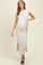 woman wearing a light grey maternity maxi dress with a side knot and side slit, showcasing her baby bump