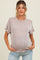 woman wearing a light beige striped maternity top with short sleeves and a visible baby bump