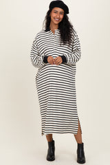 woman wearing a black and white striped maternity dress with side slits and long sleeves, showcasing her baby bump
