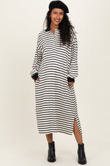 woman wearing a black and white striped maternity dress with long sleeves and side slits, styled with a black beret