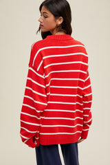 woman wearing a red and white striped oversized sweater, shown from the back