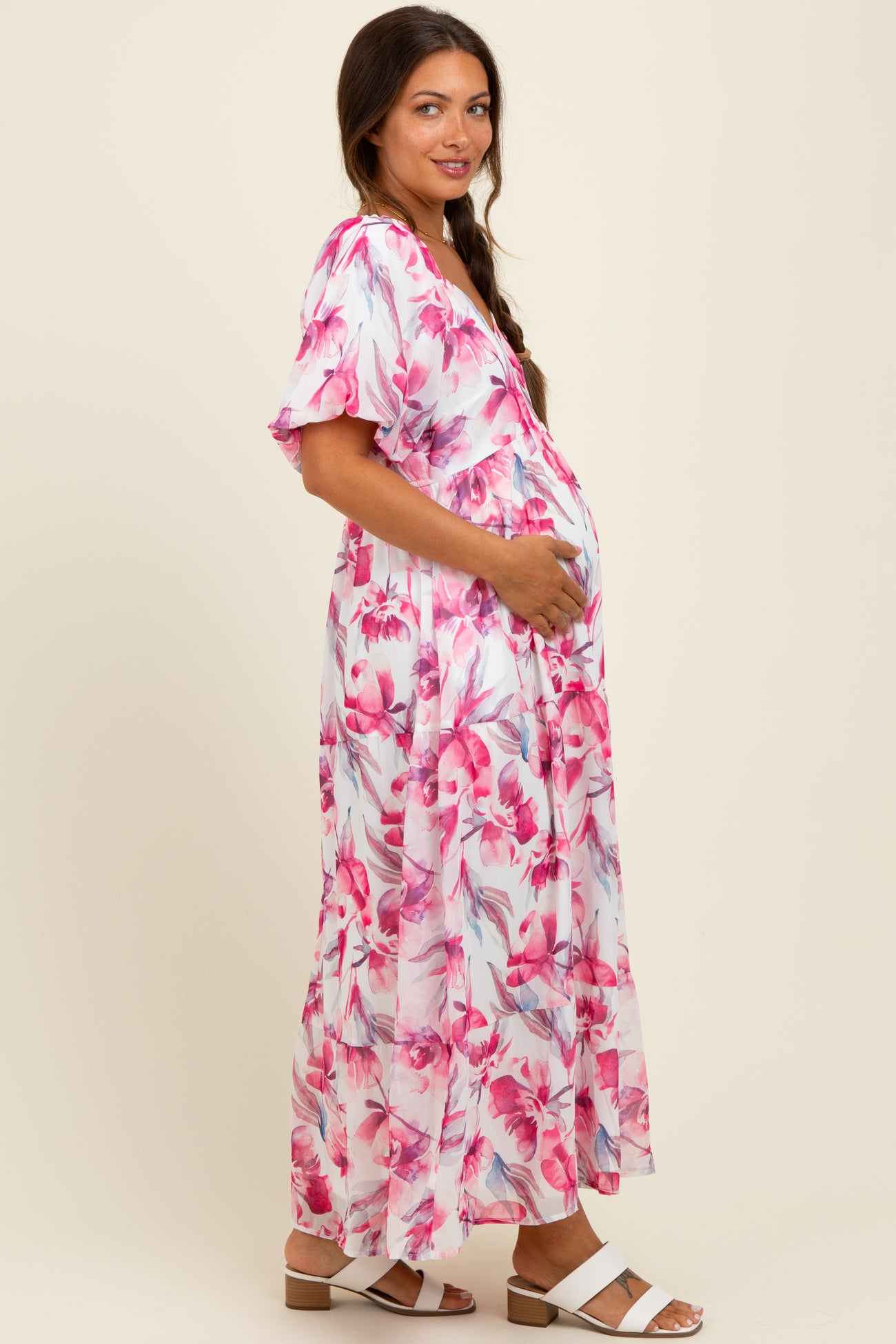woman wearing a floral maternity maxi dress with short sleeves and a baby bump visible