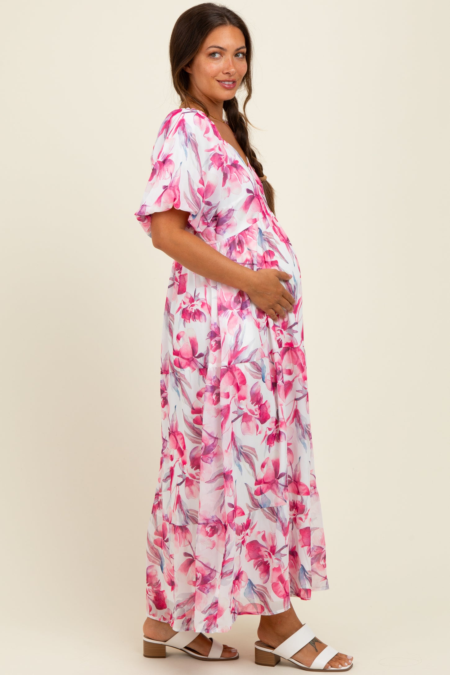 woman wearing a floral maternity maxi dress with short sleeves and a baby bump visible
