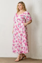 woman wearing a floral midi dress with pink and purple patterns and puff sleeves, styled with sandals