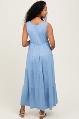 woman wearing a light blue maternity maxi dress with a tiered design, showing a relaxed fit and no visible baby bump