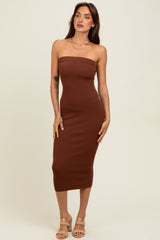 woman wearing a fitted brown strapless midi dress with a ribbed texture and strappy nude heels