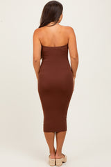 woman wearing a brown strapless maternity dress that fits snugly and falls to midi length