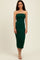woman wearing a dark green strapless bodycon midi dress and beige heels