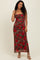 woman wearing a brown leopard print maxi dress with red floral patterns and adjustable spaghetti straps