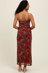 woman wearing a back view of a brown leopard print maxi dress with red floral design and thin spaghetti straps