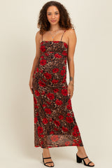 woman wearing a leopard print maternity dress with red floral design and spaghetti straps, showcasing her baby bump