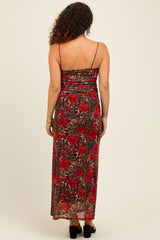 woman wearing a maternity spaghetti strap maxi dress with red floral and leopard print patterns, showing a baby bump