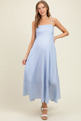 woman wearing a light blue striped maternity maxi dress with a fitted bodice and flowy skirt, showing her baby bump