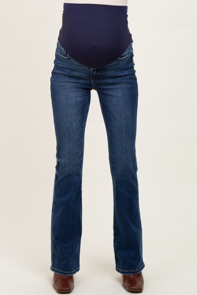 woman wearing dark wash maternity bootcut jeans with a navy blue over-the-bump panel