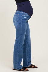 woman wearing a pair of distressed blue maternity jeans with a dark navy belly band and a visible baby bump