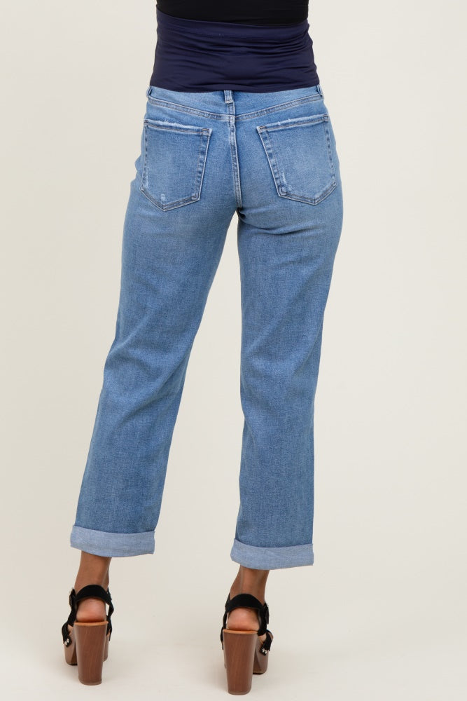 woman wearing a pair of light wash maternity jeans with rolled cuffs, viewed from the back