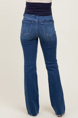 woman wearing a pair of dark wash maternity flared jeans viewed from the back