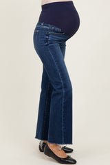 woman wearing dark blue maternity flared jeans with a high waistband and visible baby bump