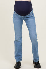 woman wearing blue maternity jeans with a dark navy over-the-bump waistband