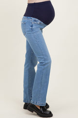 maternity wear blue bootcut jeans with a stretchy black belly panel, model showing baby bump