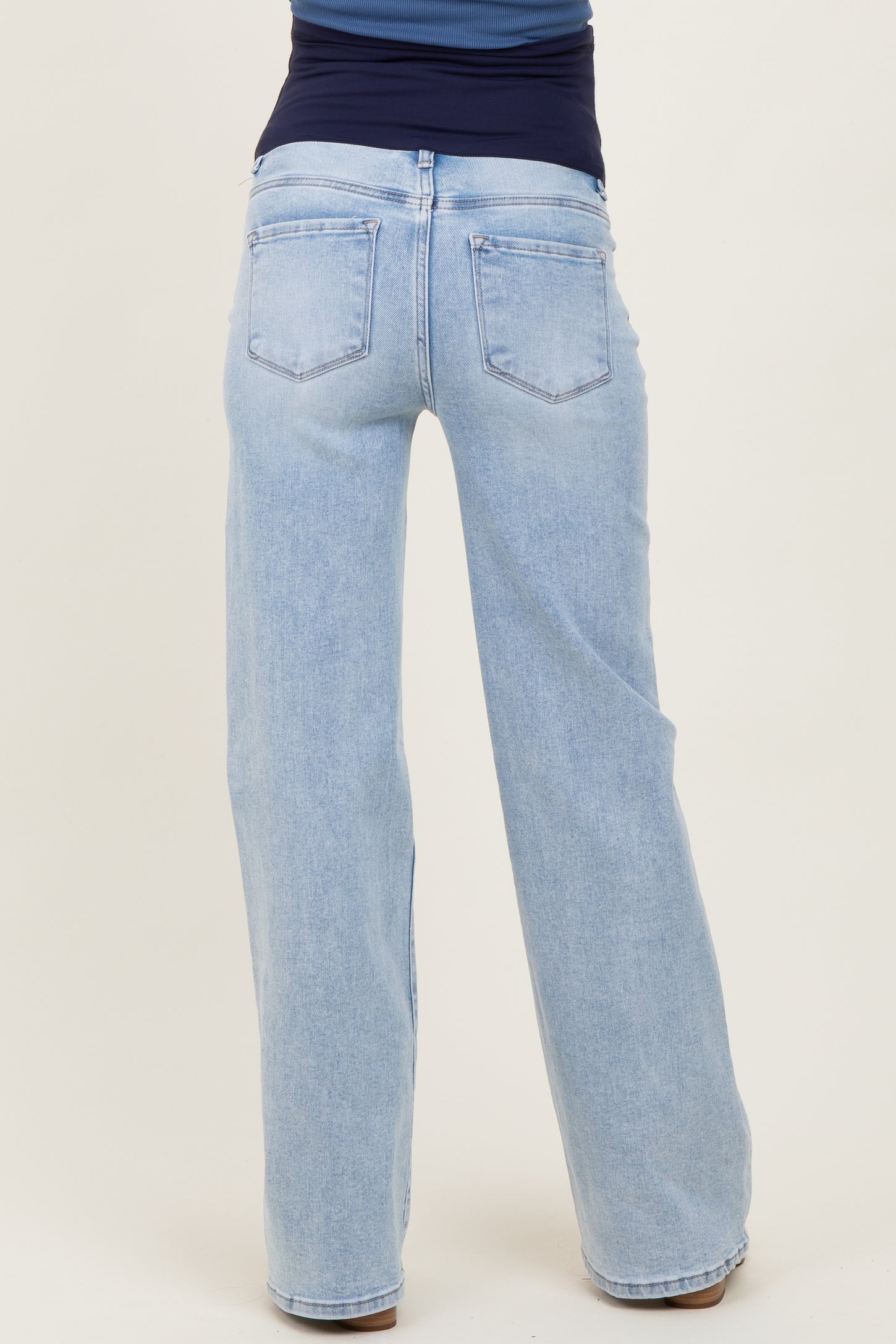 woman wearing light blue maternity wide-leg jeans shown from the back